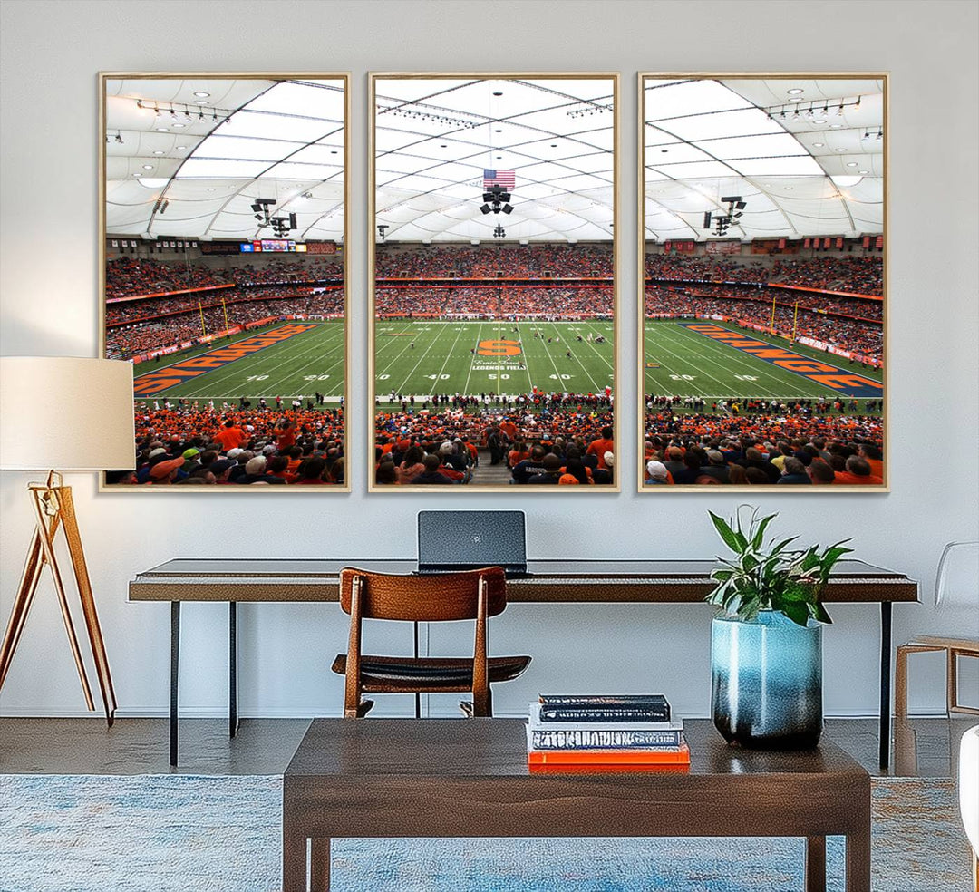 Fans fill the Syracuse JMA Wireless Dome, highlighted in orange and blue under a vaulted roof on this premium canvas print of the scene.