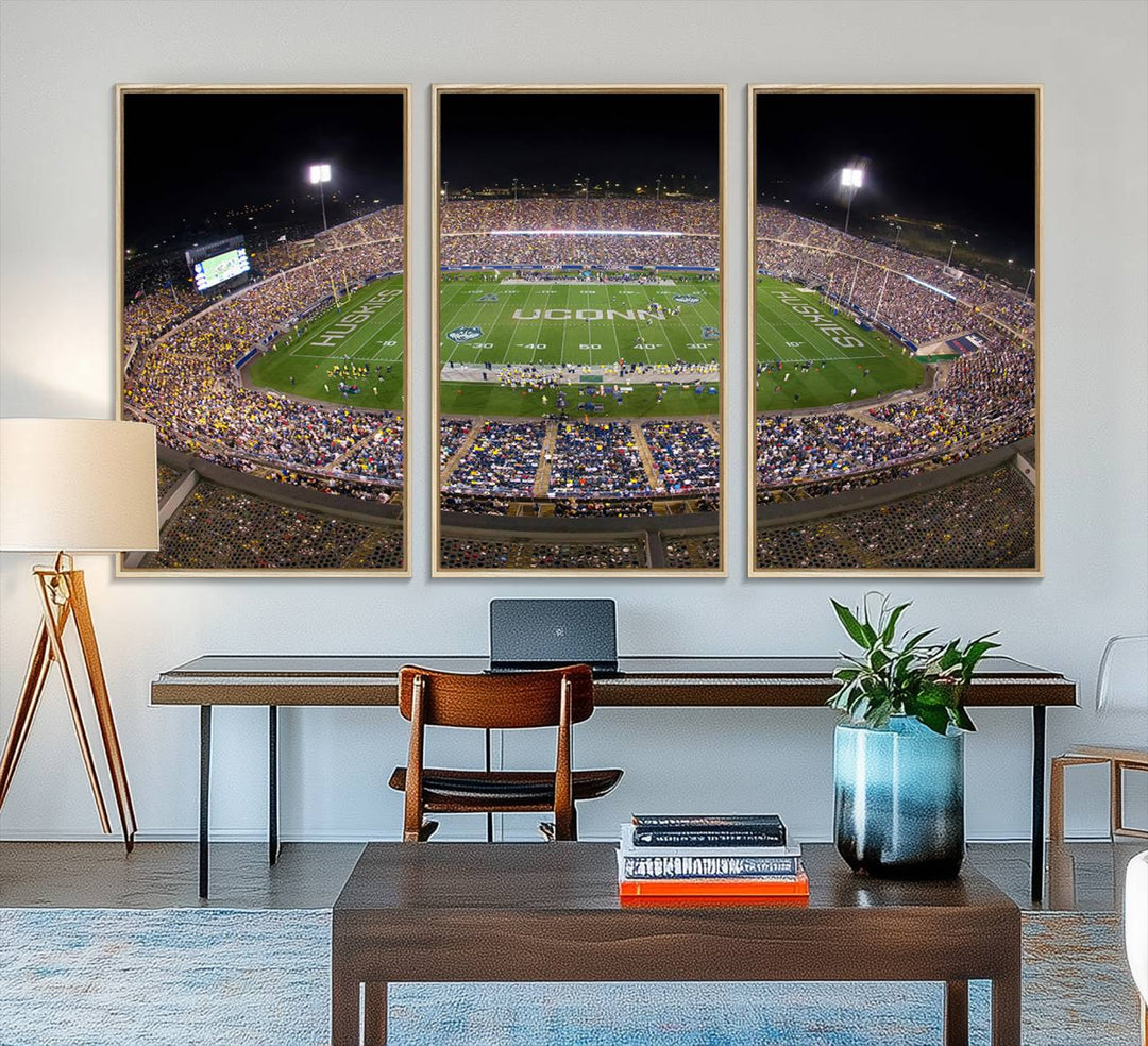 A large football stadium at night, featuring the UCONN Huskies, is depicted on the East Hartford Pratt & Whitney Stadium Wall Art Canvas Print.