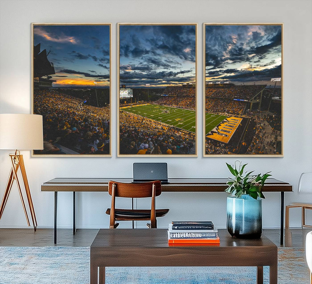 Laramies War Memorial Stadium Print captures a stunning scene of the stadium during sunset, set under a partly cloudy sky illuminated by bright lights.