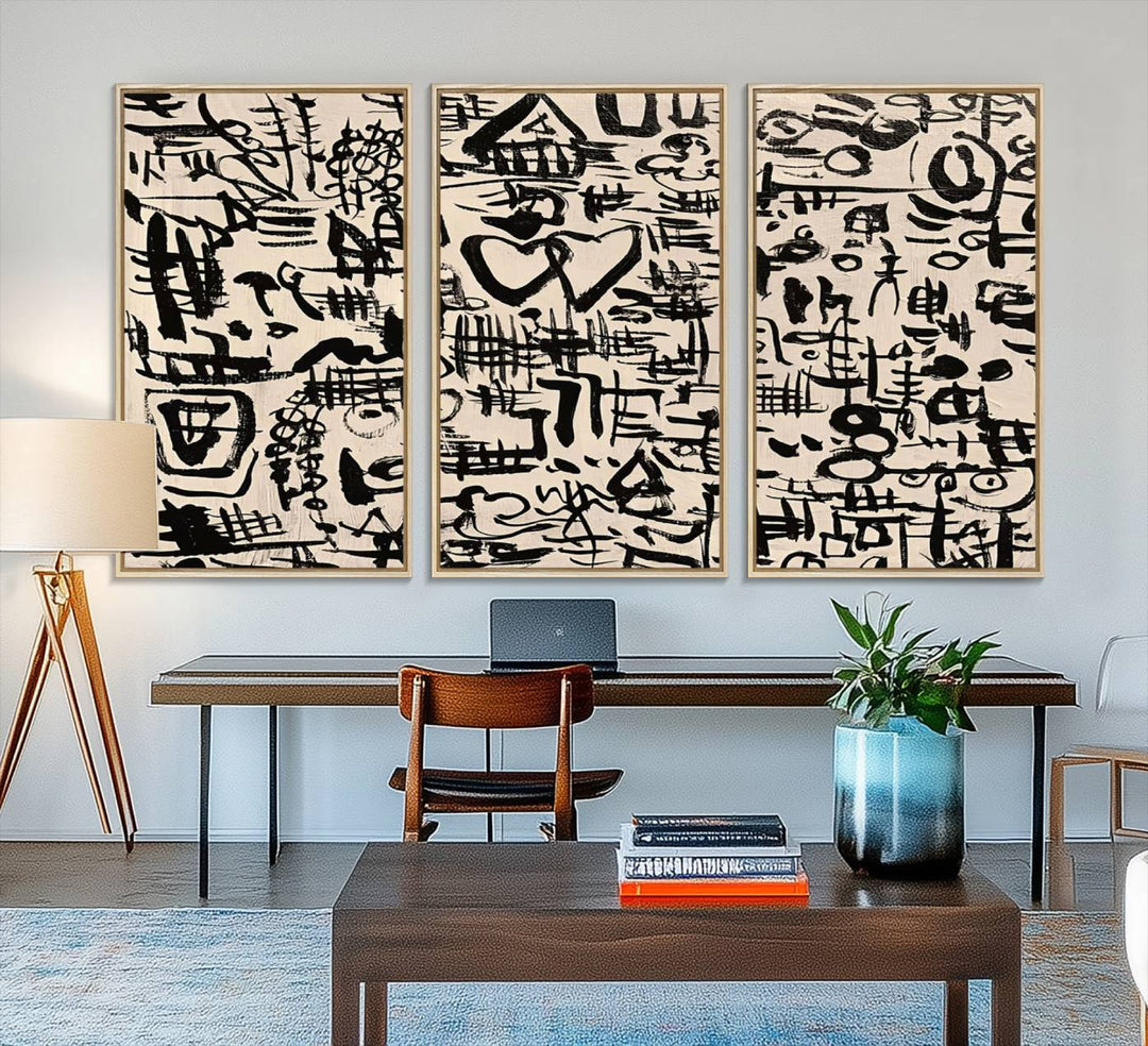 The Abstract Love and Chaos canvas is a museum-quality print featuring black symbols on a beige background, adorned with a heart and scribble design. It is framed to enhance its artistic appeal.