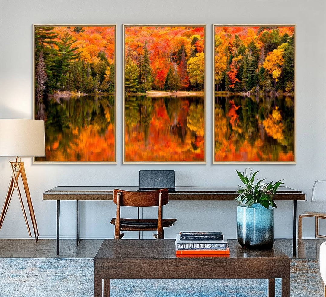 Autumn Forest Reflection Wall Art: a vibrant triptych canvas featuring fall foliage with red, orange, and yellow leaves over a calm lake.