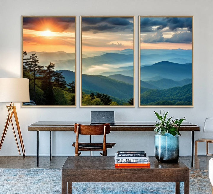 The wall art, titled Sunrise Over Mountain Range, is a canvas print that beautifully depicts layers of hills, scattered trees, and a partly cloudy sky.