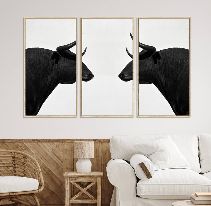 A framed canvas print featuring two black bull silhouettes, perfect for modern rustic decor.