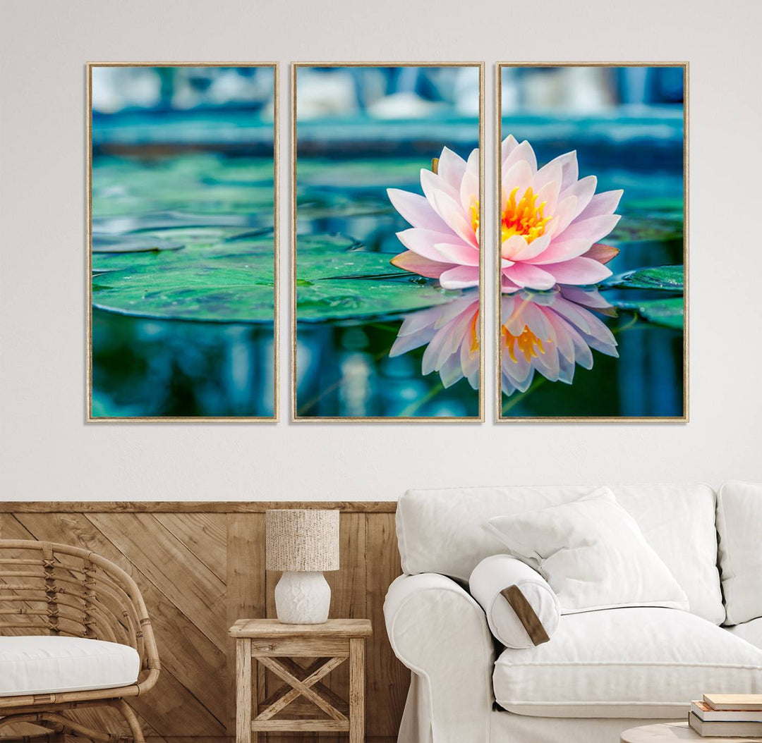 The Lotus Flower Canvas Print showcases a pink water lily with a yellow center gracefully floating on a calm pond.