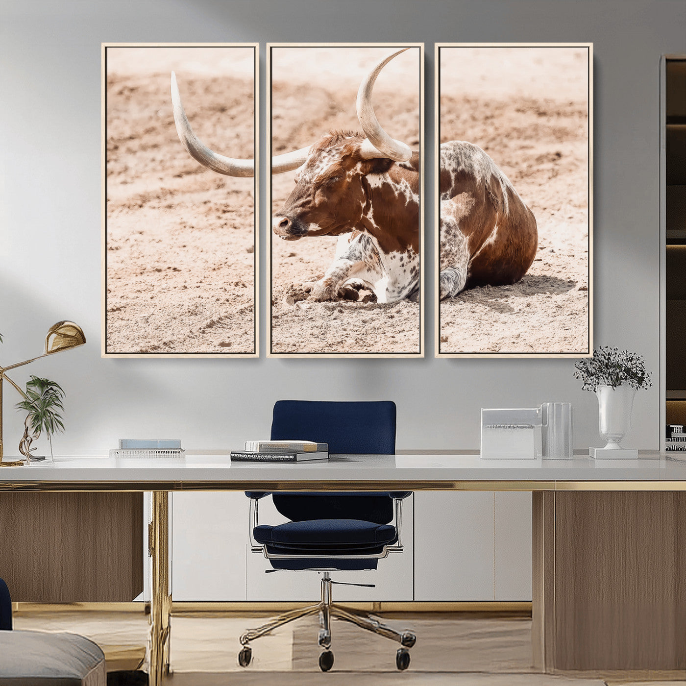Texas Longhorn bull resting on dusty ground with warm tones, ideal for rustic western or farmhouse-themed wall decor.