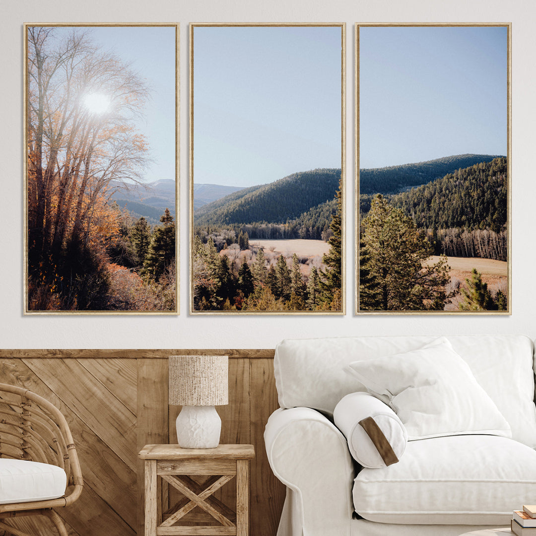 A scenic mountain valley with pine trees and autumn foliage under a clear sky, bathed in golden sunlight, creating a peaceful and rustic landscape.