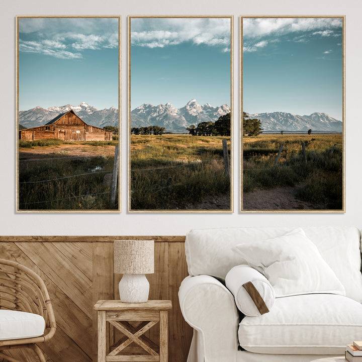 A rustic farmhouse with a wooden barn set against majestic mountain peaks under a soft blue sky, evoking peaceful countryside charm.