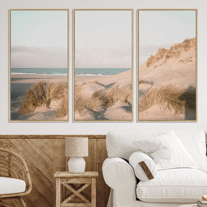Soft pastel-toned beach scene with sand dunes, windswept grasses, and a calm ocean horizon, creating a serene coastal atmosphere.