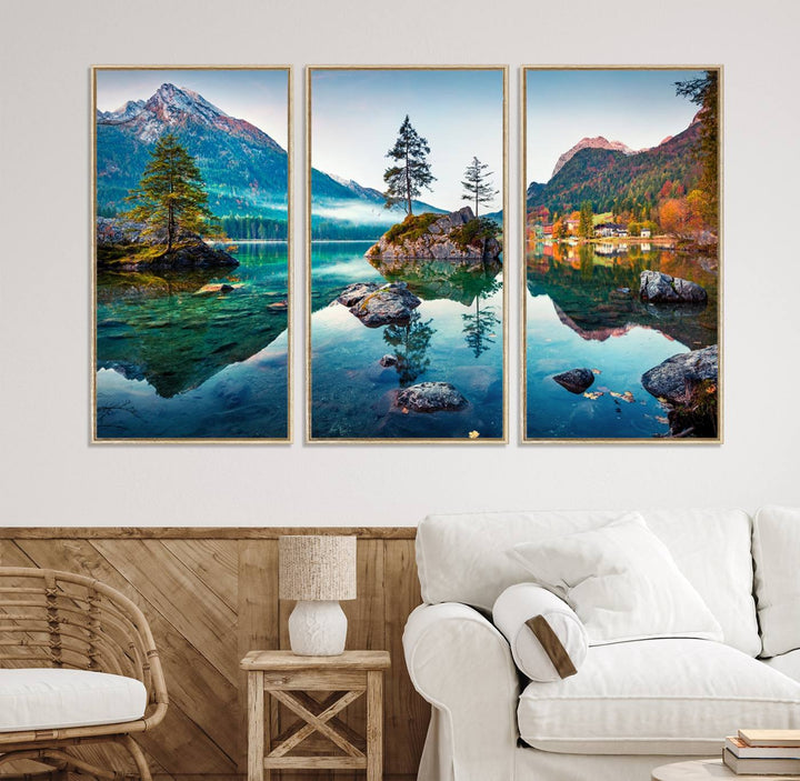 The 3-panel wall art showcases a serene mountain lake with rocky islands and trees, creating an ideal focal point for dining rooms or offices.