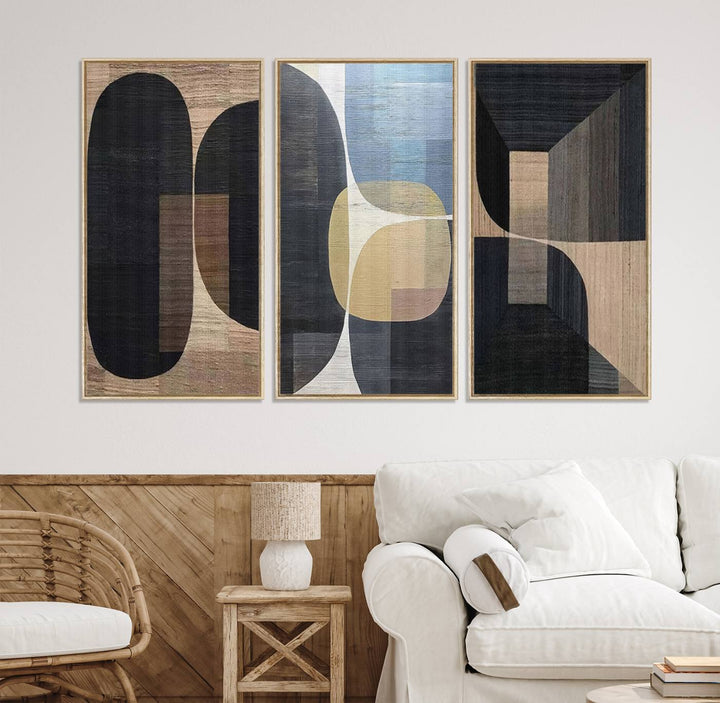 Abstract geometric wall art featuring black, gray, beige, and blue tones framed in a wooden border.