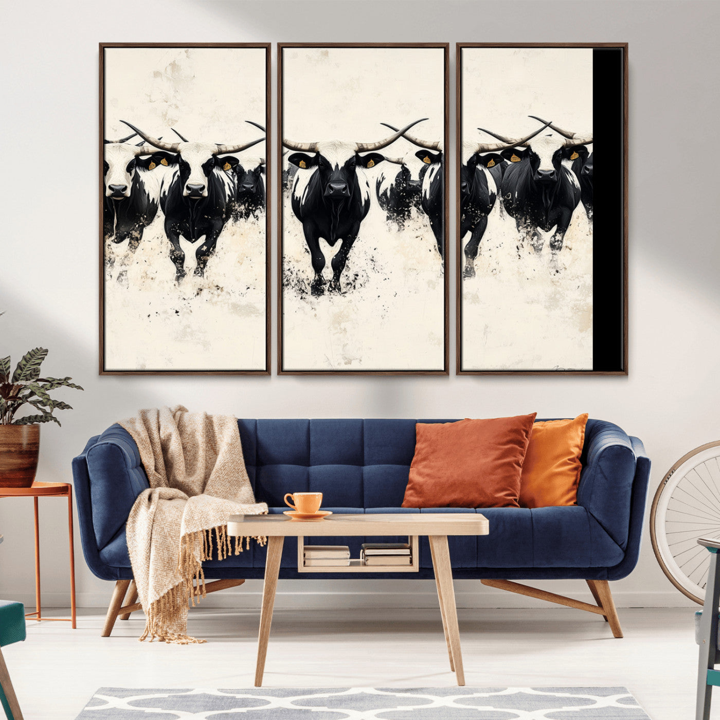 Canvas artwork of black and white Texas longhorns in a bold stampede over a minimalist background, ideal for rustic modern or Western-themed decor.