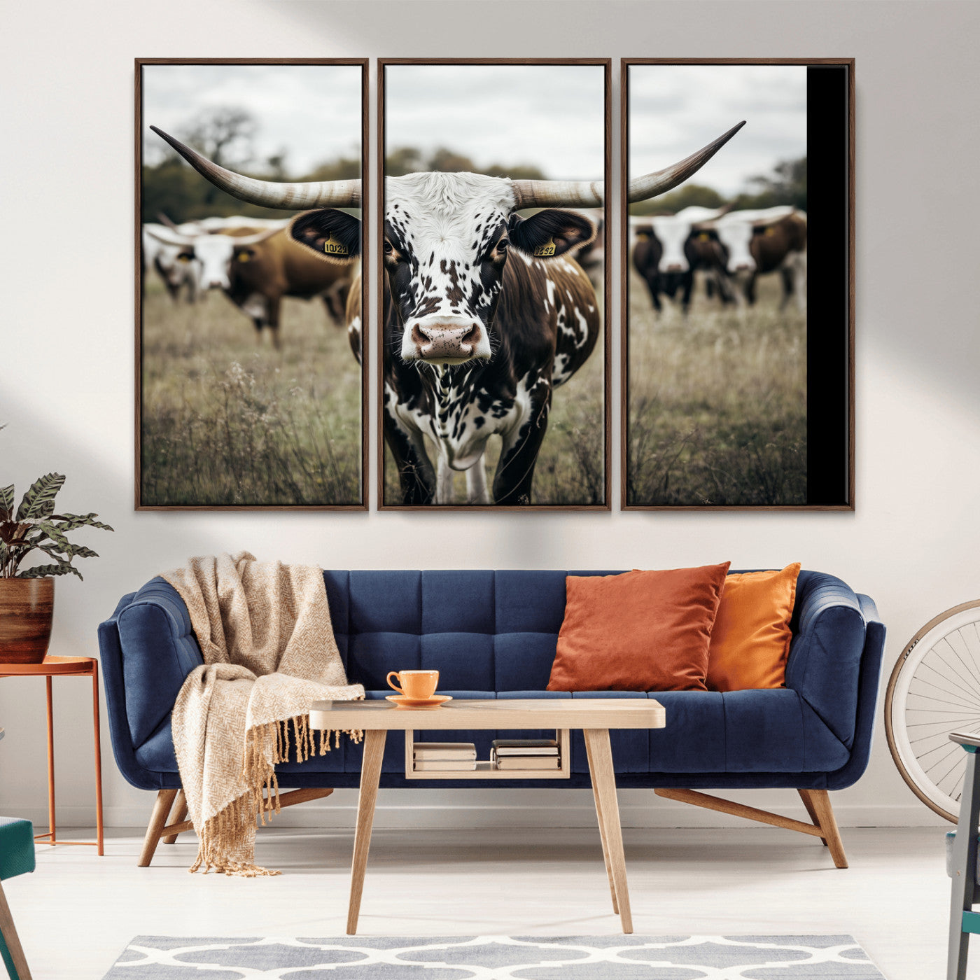 Canvas of a speckled Texas longhorn standing boldly in a field with a herd behind, perfect for rustic western or farmhouse wall decor.