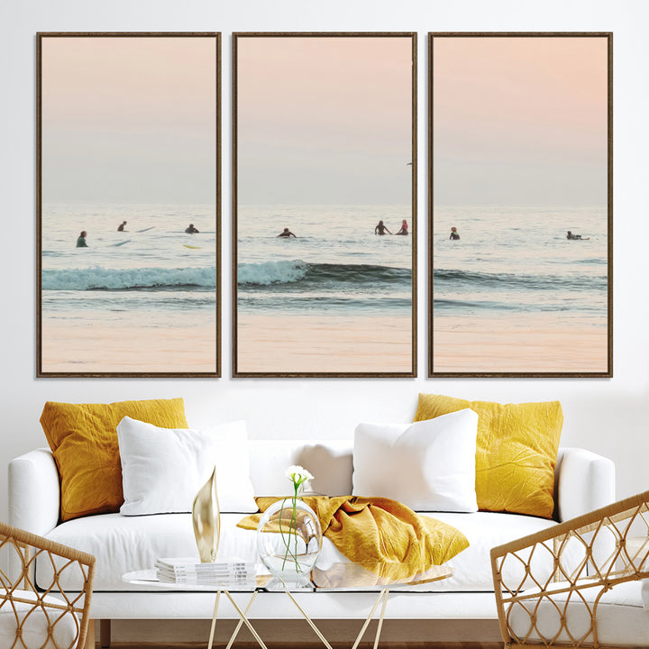 Dreamy photo of surfers waiting on soft pastel waves under a pink sunset sky, ideal for soft coastal minimalist or serene ocean-themed home decor.