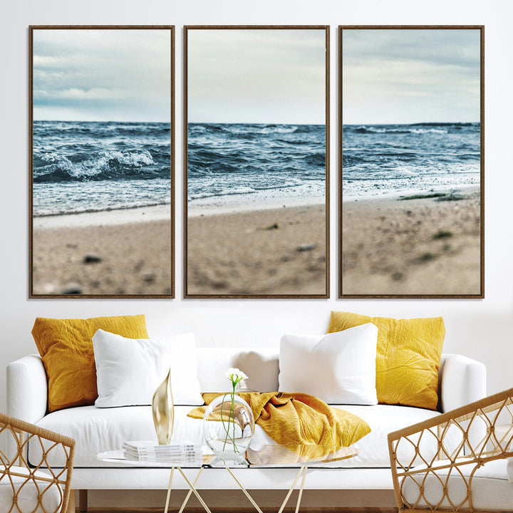 A moody ocean scene with gentle waves washing onto a sandy beach under a cloudy sky, creating a peaceful and coastal atmosphere.