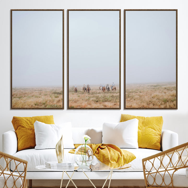 A group of horseback riders moving through a fog-shrouded field, evoking a calm Western scene with golden grasses and soft horizons.