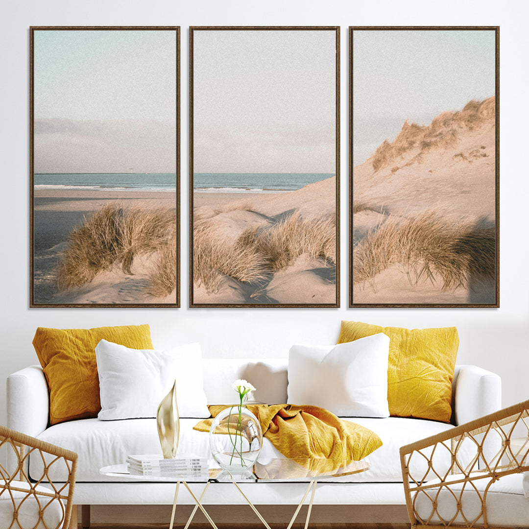 Soft pastel-toned beach scene with sand dunes, windswept grasses, and a calm ocean horizon, creating a serene coastal atmosphere.