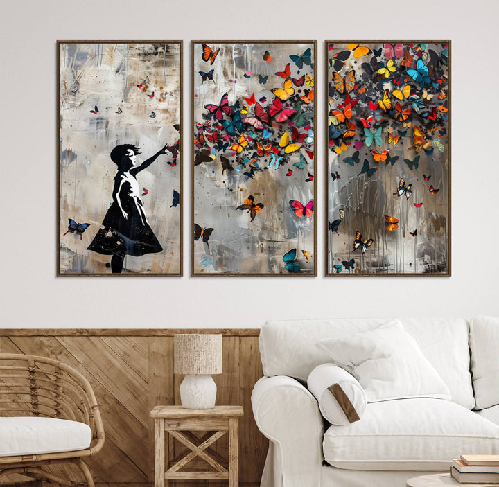 The Banksy Butterfly Girl 3-Piece Modern Graffiti Canvas Wall Art features a silhouette of a girl reaching for butterflies.