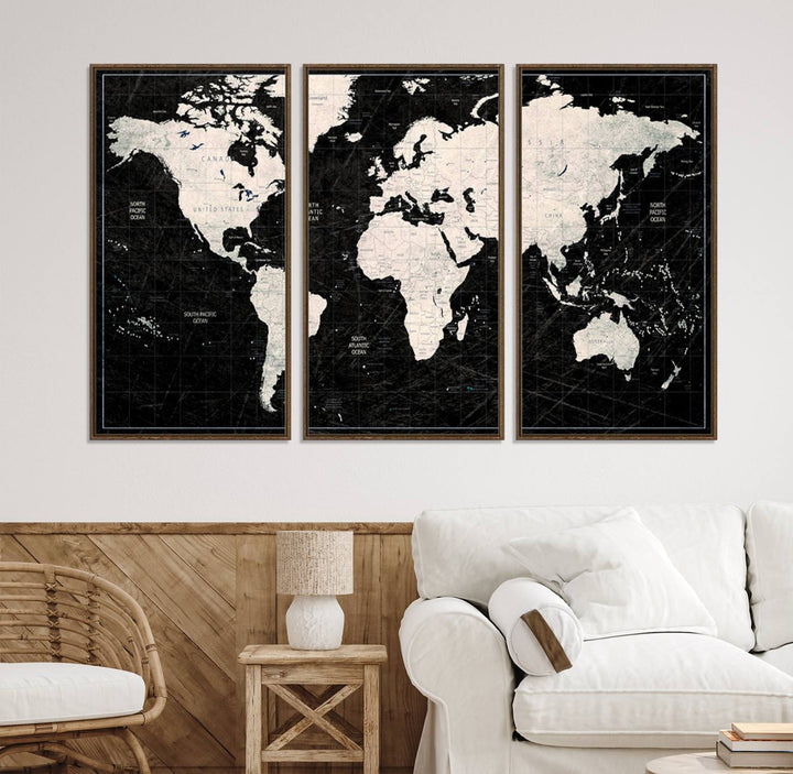 A bold global style framed black and white world map canvas print, presented in three panels, perfect for modern home or office decor.