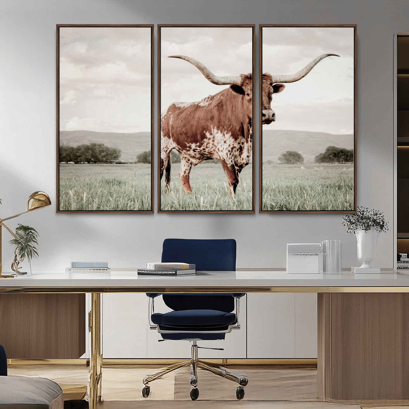 Canvas of a Texas longhorn standing in a grassy field with mountains in the background, ideal for rustic or country-style western wall decor.
