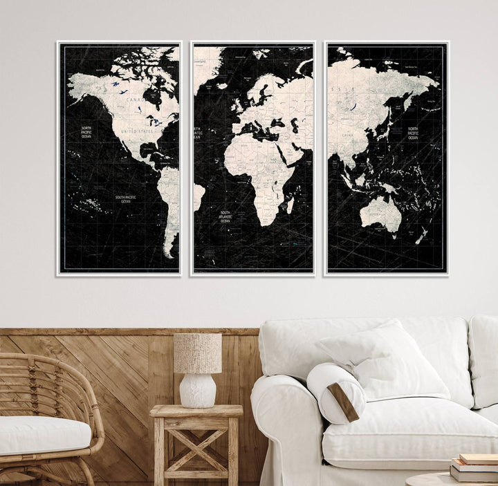 A bold global style framed black and white world map canvas print, presented in three panels, perfect for modern home or office decor.