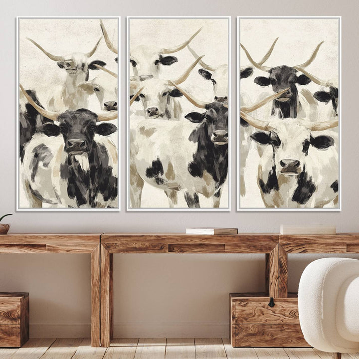 Canvas print titled Longhorn Texas Cow Drawing, depicting longhorn cattle with black and white markings, made in the USA, displayed on the wall.