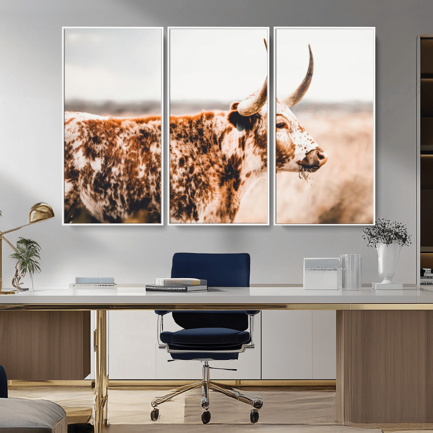 Speckled Texas longhorn with curved horns standing in a warm-toned prairie, perfect for rustic or country-style home decor.