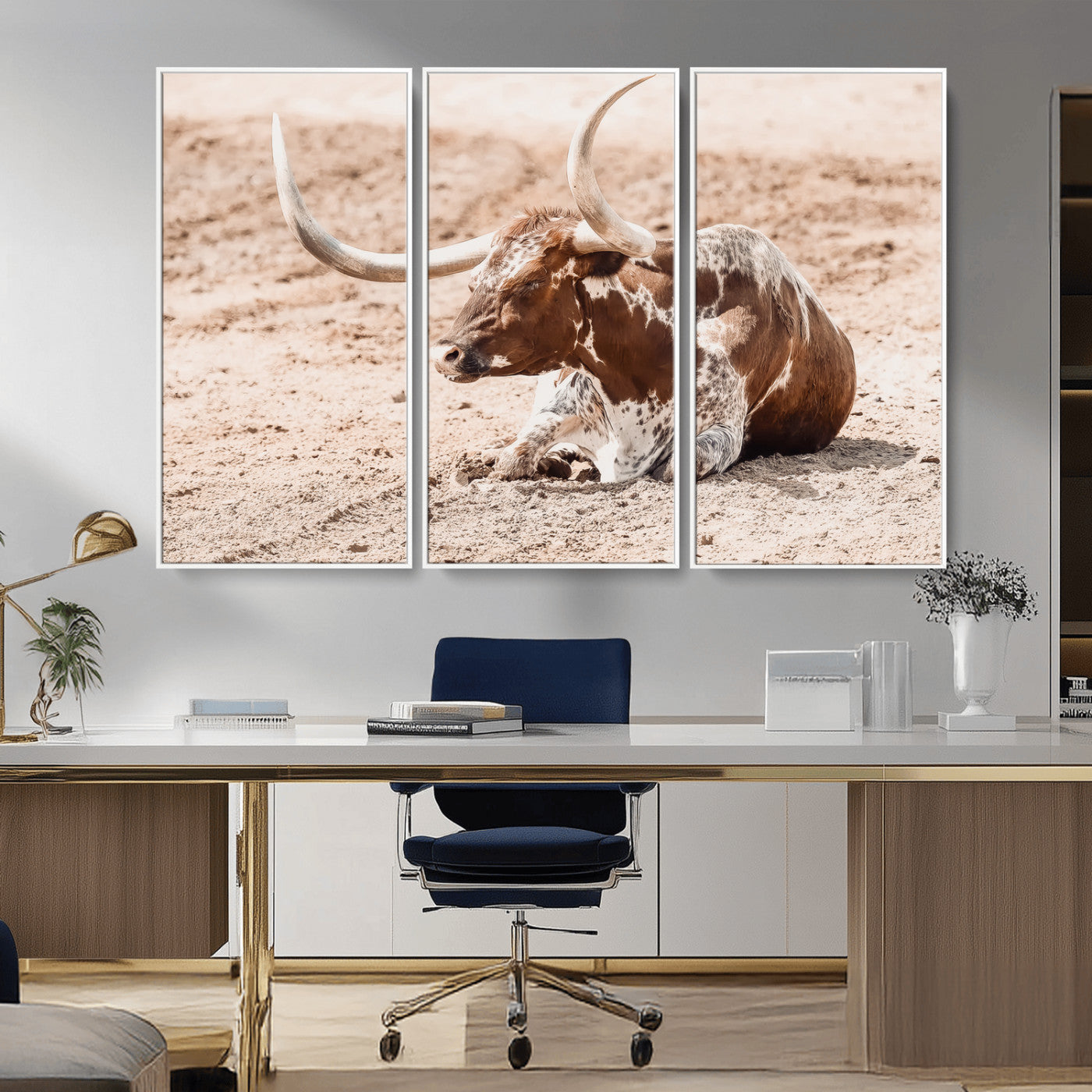 Texas Longhorn bull resting on dusty ground with warm tones, ideal for rustic western or farmhouse-themed wall decor.