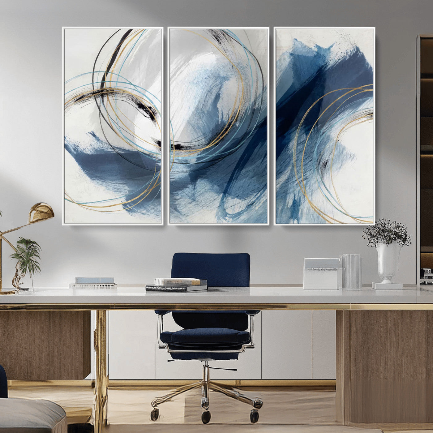Abstract wall art featuring dynamic brush strokes in shades of blue and gray, overlaid with delicate circular line patterns in gold, black, and light blue on a white background.