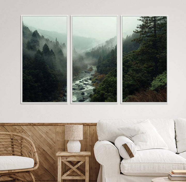 The Misty Forest Wall Art features a serene landscape with a misty river and evergreens, ideal for enhancing the ambiance of any living room or cabin.