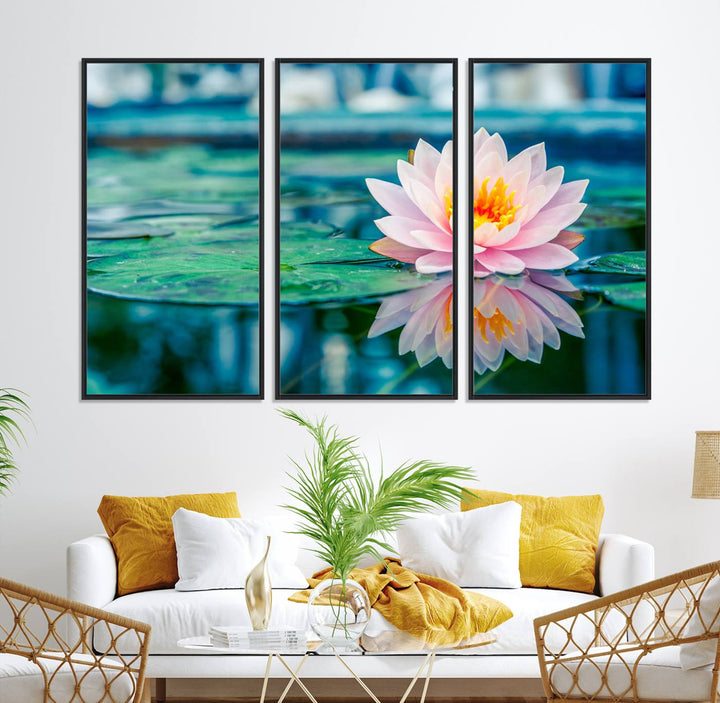 The Lotus Flower Canvas Print showcases a pink water lily with a yellow center gracefully floating on a calm pond.