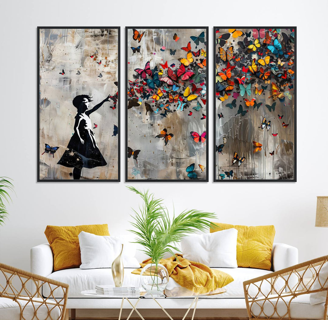 The Banksy Butterfly Girl 3-Piece Modern Graffiti Canvas Wall Art features a silhouette of a girl reaching for butterflies.