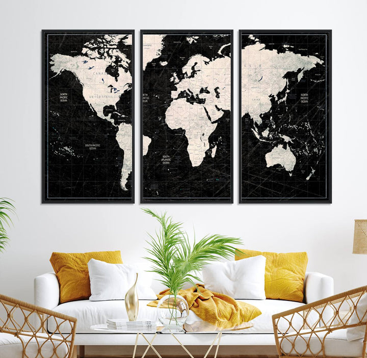 A bold global style framed black and white world map canvas print, presented in three panels, perfect for modern home or office decor.
