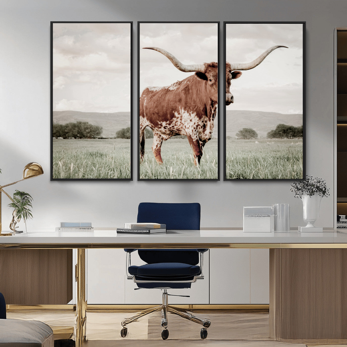 Canvas of a Texas longhorn standing in a grassy field with mountains in the background, ideal for rustic or country-style western wall decor.