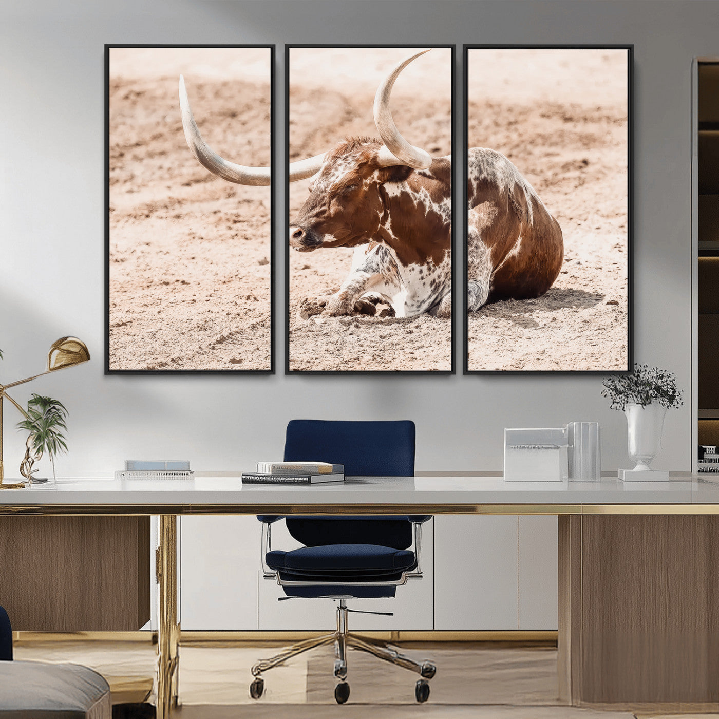 Texas Longhorn bull resting on dusty ground with warm tones, ideal for rustic western or farmhouse-themed wall decor.