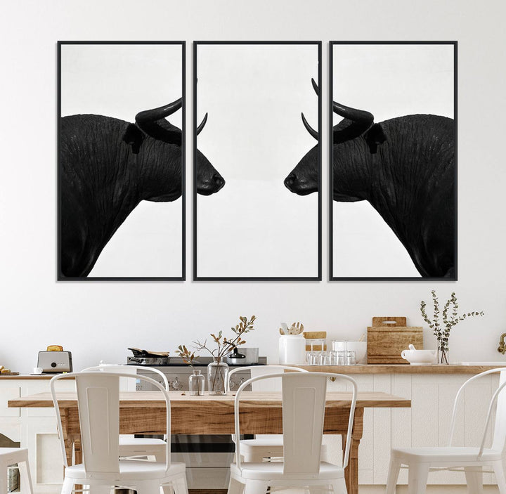 A framed canvas print featuring two black bull silhouettes, perfect for modern rustic decor.