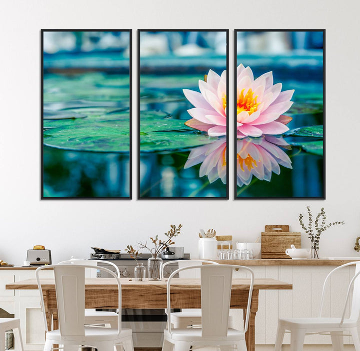 The Lotus Flower Canvas Print showcases a pink water lily with a yellow center gracefully floating on a calm pond.