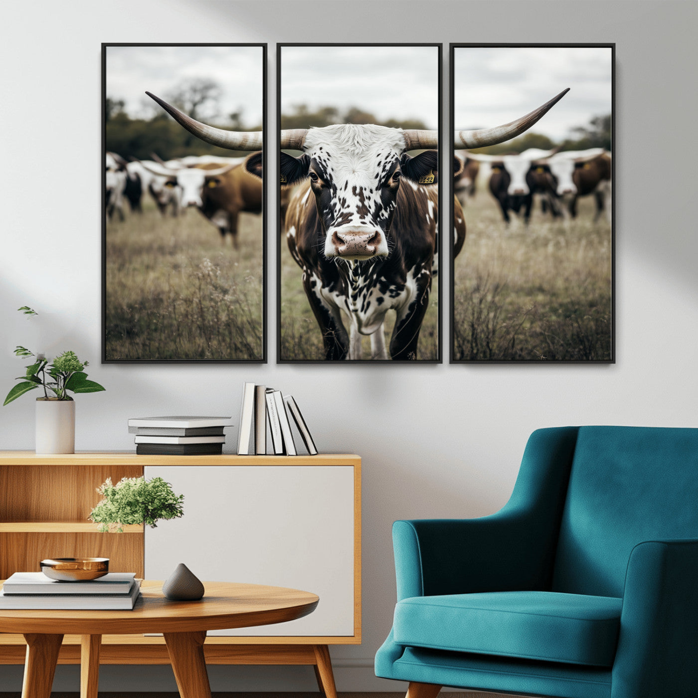 Canvas of a speckled Texas longhorn standing boldly in a field with a herd behind, perfect for rustic western or farmhouse wall decor.
