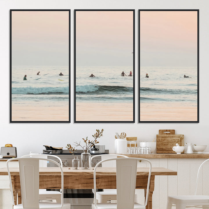 Dreamy photo of surfers waiting on soft pastel waves under a pink sunset sky, ideal for soft coastal minimalist or serene ocean-themed home decor.