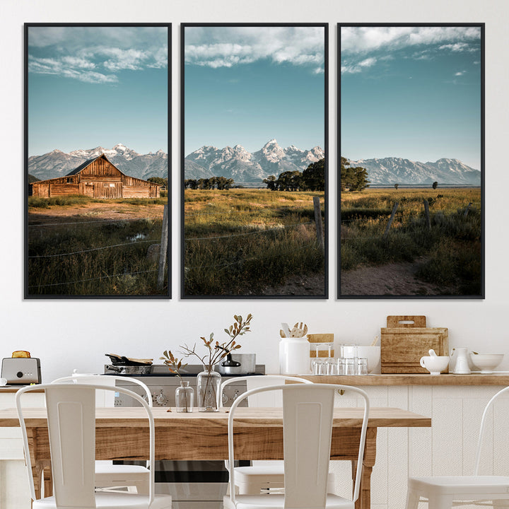 A rustic farmhouse with a wooden barn set against majestic mountain peaks under a soft blue sky, evoking peaceful countryside charm.