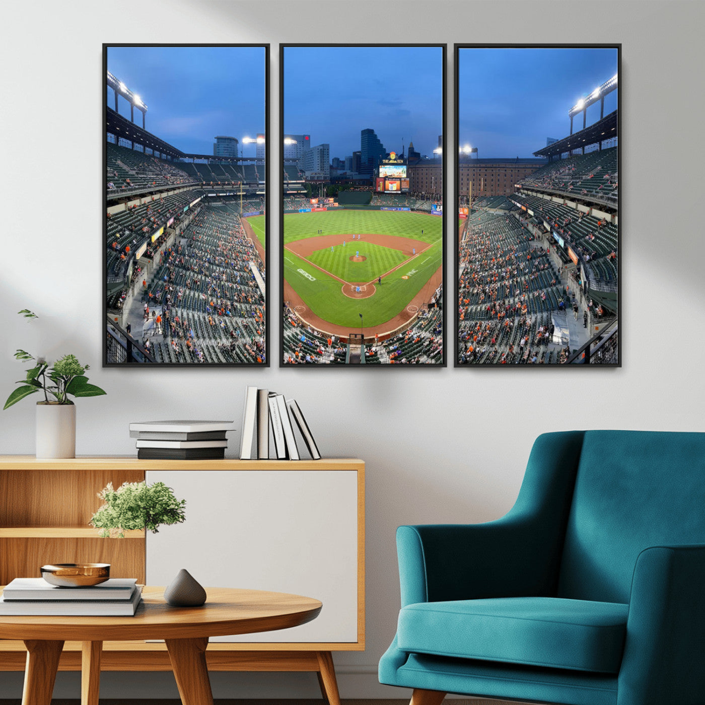 Wide panoramic view of a baseball stadium at dusk with players on the field, stadium lights illuminating the scene, and a sparse crowd of spectators in the stands.