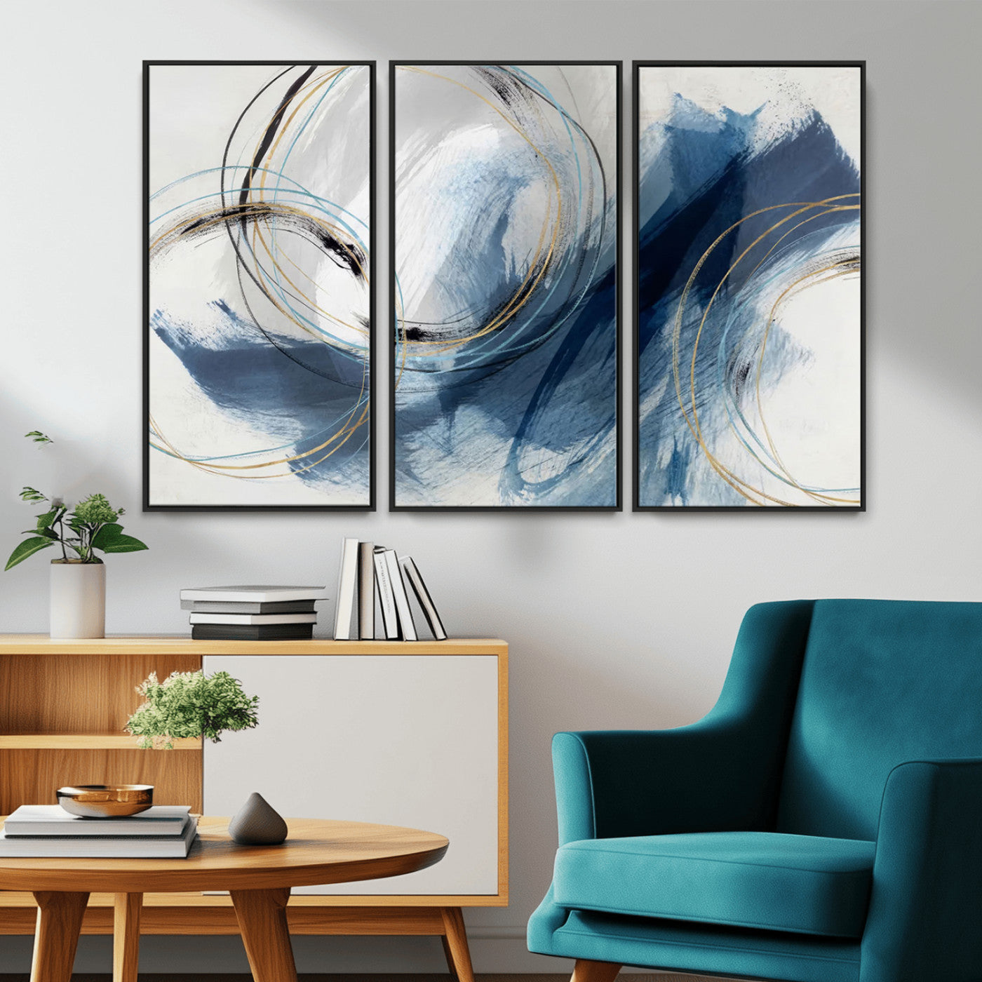Abstract wall art featuring dynamic brush strokes in shades of blue and gray, overlaid with delicate circular line patterns in gold, black, and light blue on a white background.