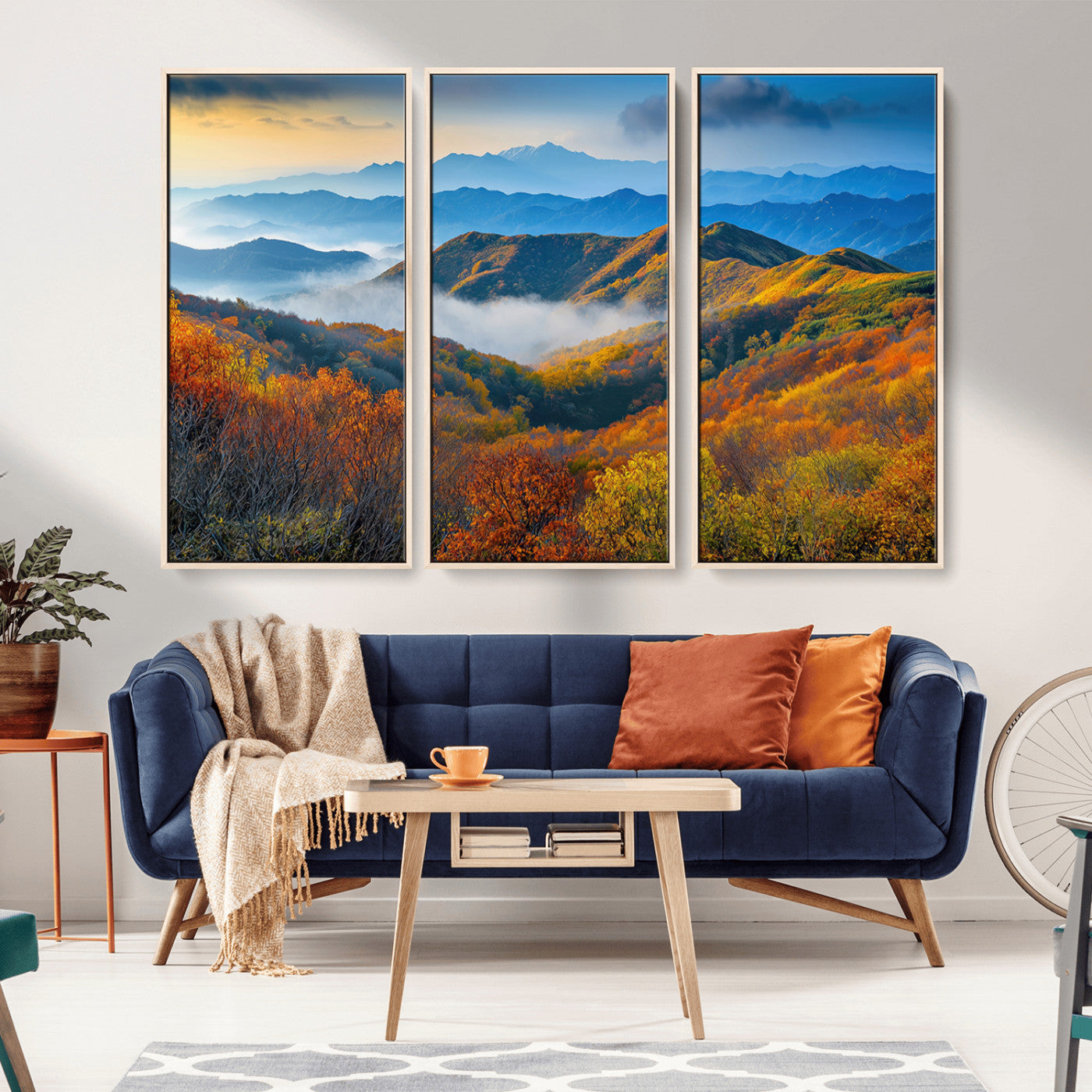 Vibrant canvas of autumn mountains with colorful trees, layered blue ridges, and soft morning fog, ideal for bright nature-themed decor.