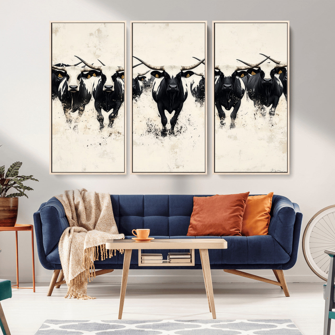 Canvas artwork of black and white Texas longhorns in a bold stampede over a minimalist background, ideal for rustic modern or Western-themed decor.