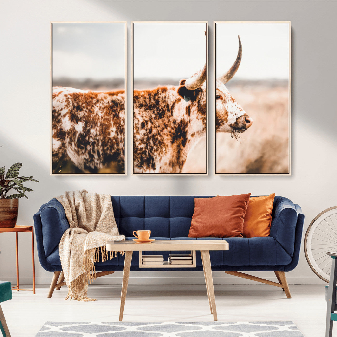 Speckled Texas longhorn with curved horns standing in a warm-toned prairie, perfect for rustic or country-style home decor.
