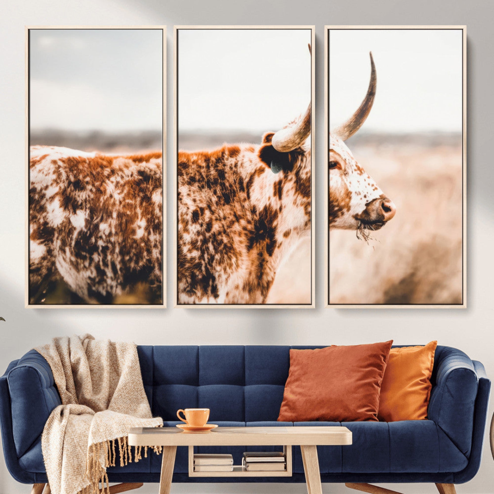Speckled Texas longhorn with curved horns standing in a warm-toned prairie, perfect for rustic or country-style home decor.