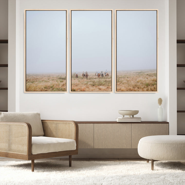A group of horseback riders moving through a fog-shrouded field, evoking a calm Western scene with golden grasses and soft horizons.