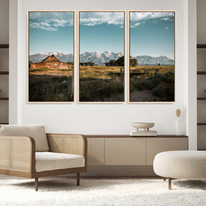 A rustic farmhouse with a wooden barn set against majestic mountain peaks under a soft blue sky, evoking peaceful countryside charm.