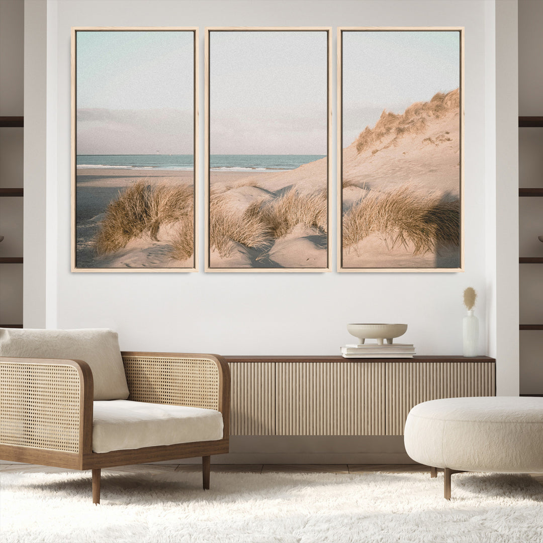 Soft pastel-toned beach scene with sand dunes, windswept grasses, and a calm ocean horizon, creating a serene coastal atmosphere.