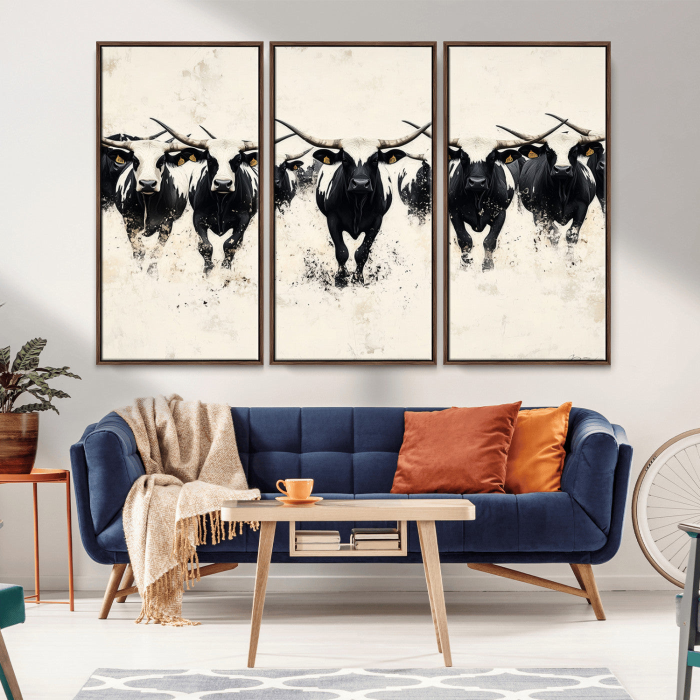 Canvas artwork of black and white Texas longhorns in a bold stampede over a minimalist background, ideal for rustic modern or Western-themed decor.