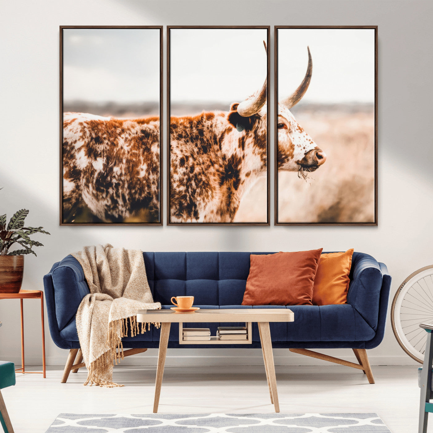 Speckled Texas longhorn with curved horns standing in a warm-toned prairie, perfect for rustic or country-style home decor.